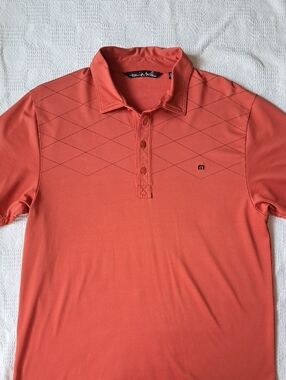 Travis Mathew Men's Polo in Coral Orange with Diamond Stitch